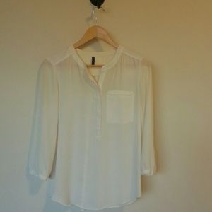 Semi-sheer cream blouse.